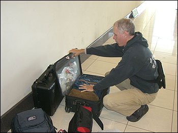 Dave rearranging luggage to prepare to board the small plane to Ndola