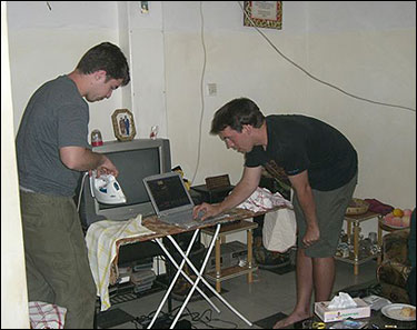 Troy (left) and Tom doing chores while waiting for dinner.