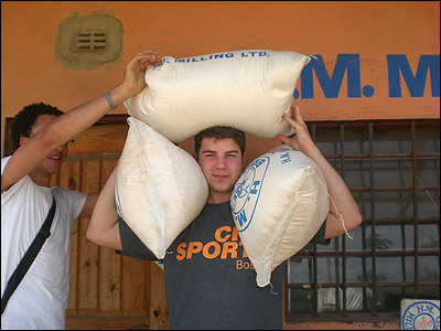 Troy testing his strength with sacks of mealie-meal.