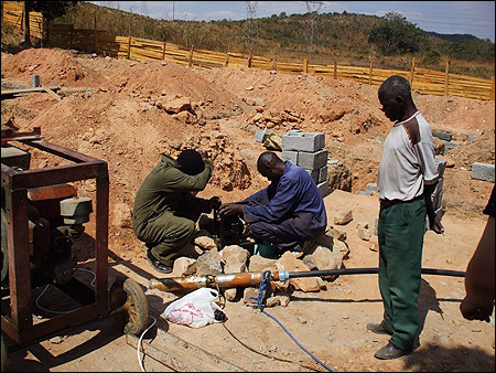 The Water Affairs workers preparing the temporary pump to test the well.