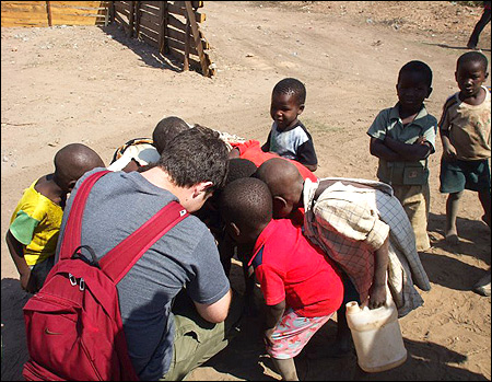 Troy showing photos to the children.