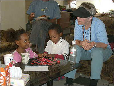 Karen, Roland and Cheri playing checkers.