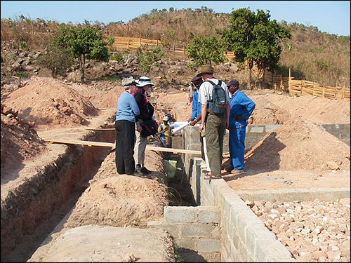 Looking at the plans at the building site.