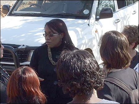 Everyone gathers around as Marcia (center) explains funding possibilities for the projects in Kantolomba.