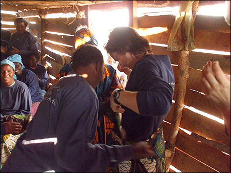 Our turn to receive gifts. Veronica wraps a skirt around Jen.