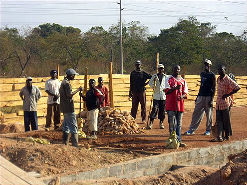 The workers leveling the foundation.