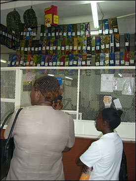 Theresa and Regina help pick out chitenge.