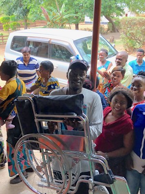 Peter unveils the new wheelchair to a delighted crowd.