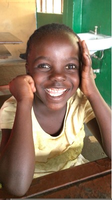 Edna, one of our bright pre-schoolers – smiling before we roll tape on our “Team A Good Start” video <<link>>