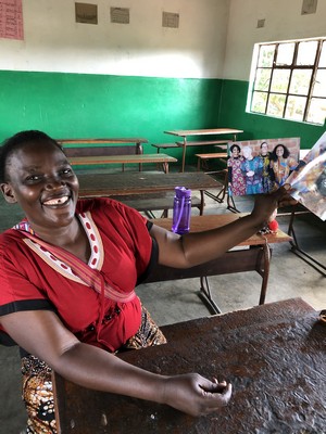  Veronica shares two of the prints she got: the four of us in our chitenge outfits given to us by the cooperative, and one of her and Sreedevi. 