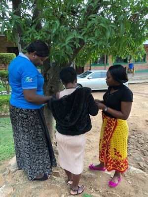 Rachel and Esther showing us how they made little bags out of mango leaves when they were children, playing our version of “house.”